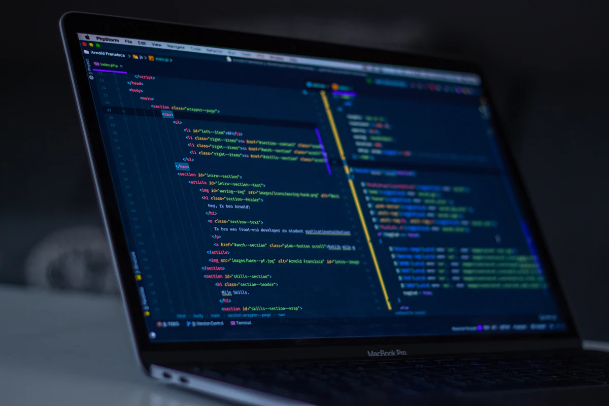 Developer writing application code on a laptop